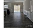 Open-concept dining area features dark floors, modern wainscoting, and sliding glass doors to the outdoors at 2054 Cane Mill Rd, Lancaster, SC 29720