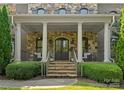 Stone and brick front porch with columns and double doors at 308 Montrose Dr, Waxhaw, NC 28173