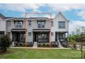 Attractive townhouse with a well-manicured lawn, welcoming front porch, and contemporary architectural design at 429 Nathaniel Way # Brx0032, Charlotte, NC 28213