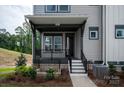 Inviting front porch with black railings and landscaping at 441 Nathaniel Way # Brx0035, Charlotte, NC 28213