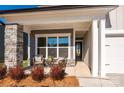 Cozy front porch with wicker chairs and a stone column at 1110 Lowland Way, Waxhaw, NC 28173
