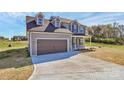 Stylish two-story home featuring a spacious driveway and an attached two-car garage at 4122 Old Monroe Marshville Rd, Wingate, NC 28174