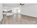 Bright open-concept living room with wood floors seamlessly connecting to the modern kitchen at 4122 Old Monroe Marshville Rd, Wingate, NC 28174