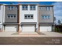 Rear exterior view of modern townhomes with garage and new construction at 428 Nathaniel Way # Brx0044, Charlotte, NC 28213
