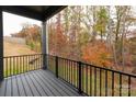 View from a private balcony overlooking a serene wooded area with colorful autumn foliage at 440 Nathaniel Way # Brx0041, Charlotte, NC 28213