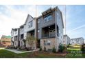 Modern townhome with a gray and white exterior, featuring a balcony and well-maintained landscaping at 440 Nathaniel Way # Brx0041, Charlotte, NC 28213