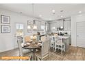 Kitchen features a dining area and gray cabinets at 608 Lispenard Ct, Mount Holly, NC 28120