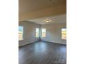 Spacious living room featuring hardwood floors and multiple windows at 608 Lispenard Ct, Mount Holly, NC 28120