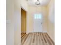 Bright foyer with wood-look flooring leading to a white door with glass panes at 751 White Jenkins Rd, Bessemer City, NC 28016