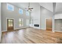 Spacious living room with high ceilings, hardwood floors, fireplace, and built-in shelving at 2610 Henry Baucom Rd, Monroe, NC 28110