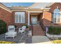 Inviting front porch with rocking chairs and brick steps at 7457 Waterleaf Ct, Stanley, NC 28164