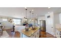 Open concept kitchen with island, stainless steel appliances, and adjacent living room at 112 Noah Ln, Troutman, NC 28166