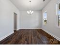 Light-filled dining room featuring a modern chandelier and hardwood floors at 1051 Bull Dog Ln, Wingate, NC 28174