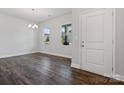 Entryway with hardwood flooring, chandelier, and natural light from windows at 1051 Bull Dog Ln, Wingate, NC 28174