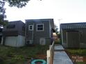 Exterior view of a home with a ramp leading to the entrance and a shed, providing accessibility and storage solutions at 112 S Cardinal Dr, New London, NC 28127