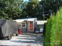 Home exterior featuring a covered porch and well-maintained gravel area, creating an inviting entrance at 112 S Cardinal Dr, New London, NC 28127
