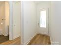 Bright foyer with white door and wood-look flooring at 1010 Lowland Way, Waxhaw, NC 28173