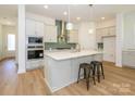 Modern kitchen with white cabinets, quartz countertops, and stainless steel appliances at 1010 Lowland Way, Waxhaw, NC 28173