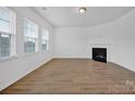 Bright living room with hardwood floors and a corner fireplace at 129 Eden Ave, Mooresville, NC 28115