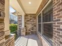 Covered porch with brick columns, stone walls, and iron railings, enhancing curb appeal at 2257 Tatton Hall Rd, Fort Mill, SC 29715