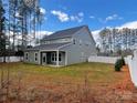 Two-story house with gray siding, a covered patio, and a fenced backyard at 328 Shinnville Rd, Mooresville, NC 28115