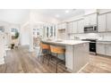 Open-concept kitchen with a center island, marble countertops, and views to an adjacent breakfast nook and living area at 332 Shinnville Rd, Mooresville, NC 28115