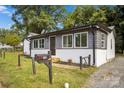 Charming ranch home with gray and white exterior and landscaped lawn at 123 Market Rd, Mooresville, NC 28115