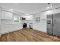 Modern kitchen featuring white cabinets, stainless steel appliances, and quartz countertops at 123 Market Rd, Mooresville, NC 28115