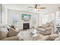 Comfortable living room featuring a fireplace, ceiling fan, and hardwood floors at 4233 Poplin Grove Dr, Indian Trail, NC 28079