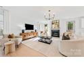 Bright and airy living room featuring a fireplace, comfortable seating, and large TV at 3623 Avalon Ave, Charlotte, NC 28208