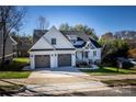 Two-story house with gray double garage doors and a front porch at 409 19Th Avenue Nw Cir # 12, Hickory, NC 28601