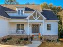 Two-story home's front entrance with gray door and porch at 409 19Th Avenue Nw Cir # 12, Hickory, NC 28601