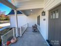 Front porch with gray door and two wicker chairs at 409 19Th Avenue Nw Cir # 12, Hickory, NC 28601