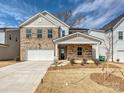 New construction two-story brick home featuring a two car garage and covered front porch at 8021 Franklin Trail St, Mint Hill, NC 28227