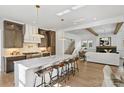 Modern kitchen with stainless steel appliances, marble countertops, and seating for four at the island at 5022 Ohm Ln, Charlotte, NC 28270