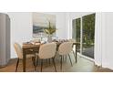 Bright dining room with wooden table and chairs, next to sliding glass doors at 734 Cantwell St, Charlotte, NC 28208