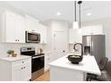 Modern kitchen featuring white cabinets, stainless steel appliances, and a kitchen island at 734 Cantwell St, Charlotte, NC 28208