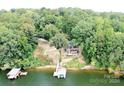 Picturesque lakefront home with dock, nestled among lush greenery with scenic water views at 152 Bridge Pointe Ln, Hickory, NC 28601