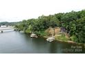 Lakefront home with private boat docks, surrounded by lush trees and tranquil water at 152 Bridge Pointe Ln, Hickory, NC 28601
