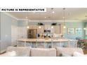 Open-concept kitchen and living room featuring a large island with seating and stainless steel appliances at 145 Sari St, Troutman, NC 28166