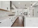Modern kitchen with white cabinetry, stainless steel appliances, and hardwood floors at 2140 Indigo Branch Rd, Indian Land, SC 29707