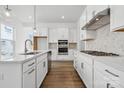 Modern kitchen with stainless steel appliances, white cabinetry, and hardwood floors at 3112 Beacon Heights Rd, Indian Land, SC 29707