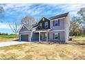 Charming two-story home features a two-car garage, welcoming porch, and modern exterior paint at 4206 Old Monroe Marshville Rd, Wingate, NC 28174