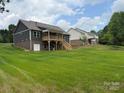 Exterior showcasing back of home with deck overlooking spacious, well maintained backyard at 59 Browning Dr, Taylorsville, NC 28681
