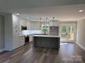 Bright kitchen featuring an island, stainless steel appliances, and access to the deck at 59 Browning Dr, Taylorsville, NC 28681