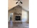 Bright living room with vaulted ceiling, stone fireplace with mantel, and view to the bath at 59 Browning Dr, Taylorsville, NC 28681