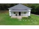 Charming single-story home with a welcoming front porch and well-maintained lawn surrounded by mature trees at 113 Fairview St, Clover, SC 29710