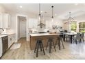 Bright kitchen features an island with bar seating, modern lighting, and an adjacent dining area at 1025 Baylor Grove Rd, Monroe, NC 28112