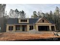 New construction home featuring a dark roof and wood framing at 1025 Baylor Grv, Monroe, NC 28112