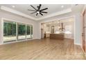 Spacious living room open to kitchen featuring wood floors, large windows, and sliding glass door at 1025 Baylor Grv, Monroe, NC 28112